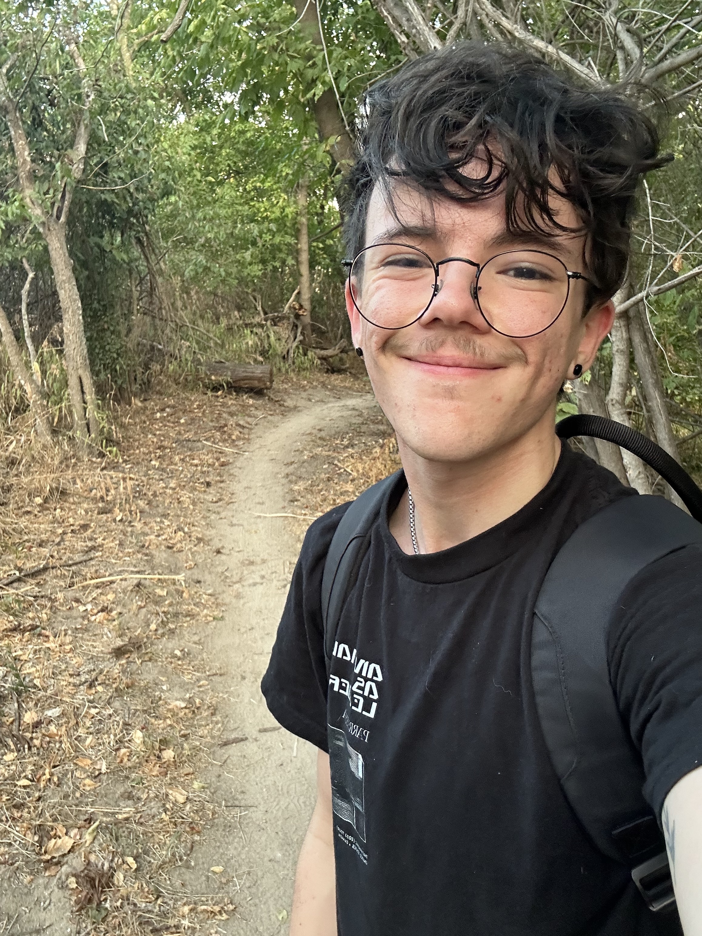 Wyatt Denham hiking on a trail